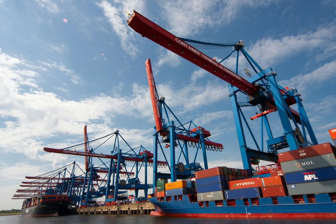 Gantry cranes loading containers onto a cargo vessel
